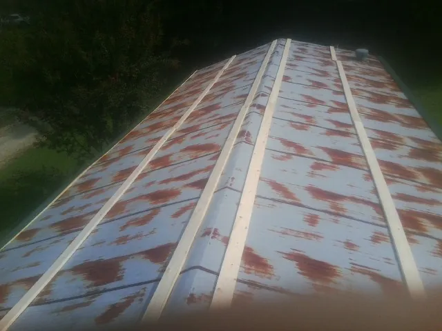 Rusted metal roof panels with new wood purlins before replacement — Storm Damage Roof Repair in Mehama by Roofing Brothers